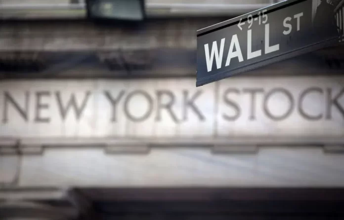 A Wall Street sign is pictured outside the New York Stock Exchange in New York, October 28, 2013. REUTERS/Carlo Allegri