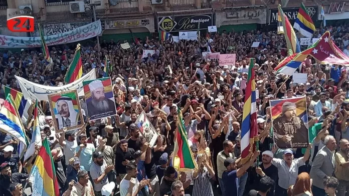 People take part in a protest against Syria's President Bashar al-Assad in the southern Druze city of Sweida, Syria, September 8, 2023. Suwayda 24