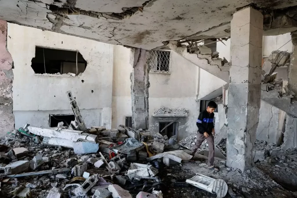 A Palestinian boy checks the damage at a mosque which was hit in an Israeli air strike, in Jenin refugee camp in the Israeli-occupied West Bank October 22, 2023.