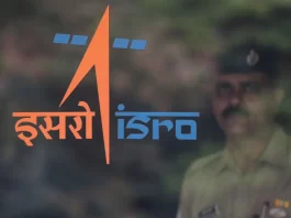 A security guard stands behind the logo of Indian Space Research Organisation (ISRO) at its headquarters in Bengaluru, India, June 12, 2019. REUTERS/Francis Mascarenhas